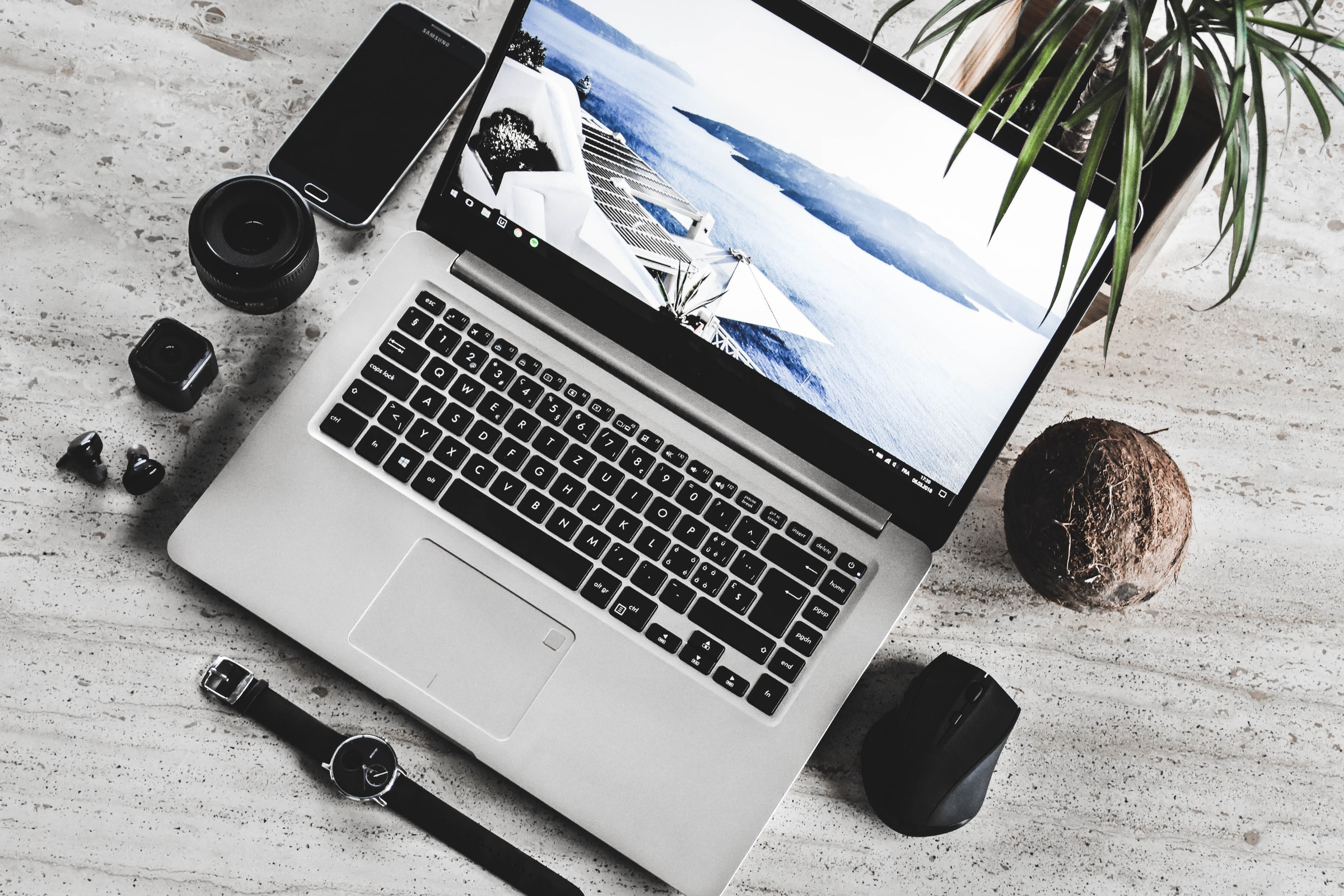 Unfocused image of a windows laptop surrounded by a tropical environment.